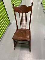 Front view showing pressed back design and wooden seat