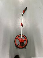 Front view of Lufkin contractor measuring wheel with extended handle and visible measuring wheel and counter.