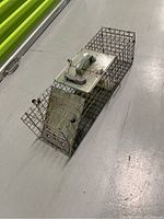 Oblique top-front side view showing metal wire cage and handle on top metal plate