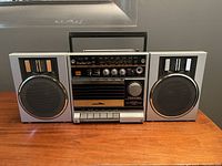 Front view of vintage Toshiba RT-SX1 BomBeat radio cassette player with detachable speakers showing entire unit and handle.