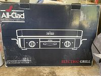 Box of All-Clad electric grill showing brand and model illustration
