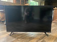 Photo of Vizio 40-inch flat screen TV on wooden floor with window in background