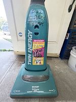 Front view of Sharp Twin Energy upright vacuum showing model and energy label with handwritten notes for compatible bag references.