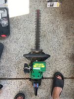 Top view of Weed Eater GHT-22 gas-powered hedge trimmer showing the blade and engine