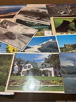Overview of several placemats with vintage black-and-white and color photographic scenes including buildings, wilderness, and skiing action.