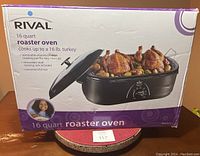 Box showing Rival 16 quart roaster oven with a cooked turkey and vegetables inside. Features listed include cooking for up to 16 lb turkey and removable parts for easy cleanup.