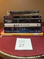 Stack of eight books showing titles and authors related to spooky and ghostly themes for young readers.