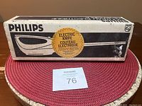 Original box of vintage Philips electric knife with the label 'Electric Knife' in French and English, showing wear on top and sides.