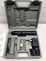 Full view of cordless rotary tool, charger, multiple bits and accessories in carrying case.
