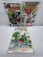 Three Fantastic Four comic books: Annual #19, issue #250, and What If...? #36 shown on a white surface.