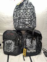 Front and top view showing all three backpacks including two Cage Fighter backpacks and one skull pattern backpack