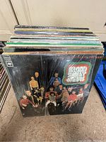 View of multiple vinyl record albums stacked, front album is Blood, Sweat & Tears with group photo on cover