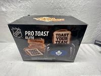 Photo of the NHL Pro Toast Elite toaster box featuring Toronto Maple Leafs logo and images of toasts with message.