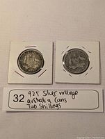 Reverse sides of 1916 and 1918 Australian Two Shillings coins showing the Australian coat of arms and denomination.