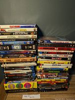 Photo of large stack of DVDs showing spines and titles for identification and quantity verification