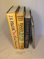 Spine view of four J.K. Rowling books showing titles: The Casual Vacancy, Harry Potter and the Cursed Child, and two additional books.