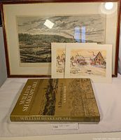 Three framed prints with a hardcover William Shakespeare book in front: a large black and white print and two smaller colored prints.