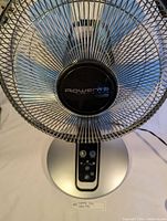 Front top view showing the Rowenta logo on the fan center and the overall fan design.