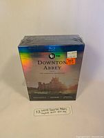 Front view of sealed Downton Abbey Blu-ray complete series box set showing holographic cover and price sticker.