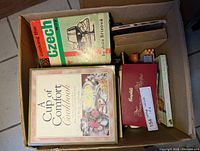 Box of various vintage cookbooks including A Cup of Comfort Cookbook and Cooking the Czech Way.
