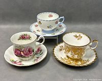 Three English teacups and matching saucers from Shelley, Paragon, and Royal Albert with floral and gold designs.
