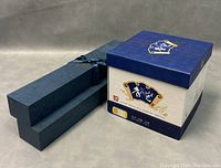 Box exterior featuring traditional blue and white Chinese motifs with emitting packaging details