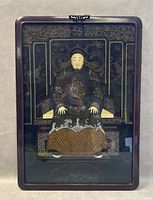 Framed reverse glass painting showing a sitting Chinese emperor in traditional embroidered robe with intricate gold background and decorative throne.