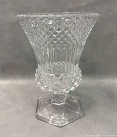 Front view of the diamond cut crystal pedestal vase showing the flared upper rim, detailed diamond cut pattern, and hexagonal base.
