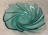 Top view of aquamarine glass serving bowl showing swirl pattern and original label