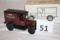 Front and side view of the 1923 Chevrolet delivery truck bank with UTZ Hanover Home Brand Potato Chips advertising, original packaging visible in the background, lot number card included.