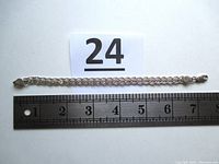 Full view of the bracelet alongside a ruler showing length as 7 inches, the bracelet laid flat in full detail.