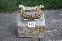 Full view of vintage cast iron boot scraper mounted on a rectangular granite base, with visible rust and old paint.