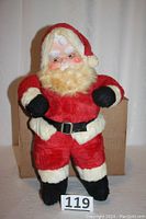 Full body shot of the 17-inch vintage Santa Claus figure in red plush suit and black accessories