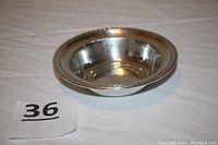 Side view of the vintage sterling silver round bonbon/nut bowl showing the shape and rim with decorative beaded edge.