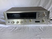 Front view of Sansui Stereo Receiver 551 showing control knobs and display panel.