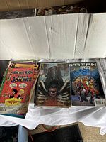 Box interior showing three visible comics: Walt Disney Presents: The Richie Rich and Jackie Jokers; Aliens; Titan A.E.