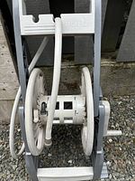 Front close-up view of the Ronix garden hose reel showing plastic reel and hose wrapped around it.