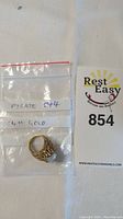 Ring and labeled bag with auction card
