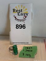 Ring displayed in front of Rest Easy auction card and handwritten note