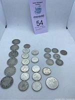 Photo showing arranged Canadian silver coins including dimes, quarters, and half dollars.