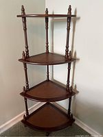 Full view of the 4 shelf corner unit showing the wooden frame and leather-inset shelves.