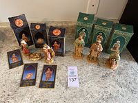Overview of six resin nativity figures displayed with original boxes, showing packaging and arrangement.