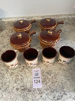 4 vintage onion soup bowls with lids and 4 floral Biltons England mugs arranged on countertop