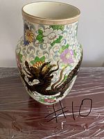 Front view of the vase showing dragon and floral painting.