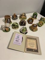 Overview of all 12 porcelain woodland animal sculptures alongside paperwork.