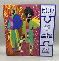 Puzzle box front showing colorful graphic of two figures, title, piece count, and branding