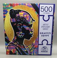 Front of puzzle box showing colorful graffiti profile silhouette and puzzle piece count.