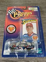 Front view of new Winner's Circle packaged Dale Earnhardt Jr. Superman racing car collectible with card and badge visible.
