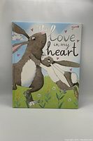 Front cover of the jumbo soft children's book 'The Love In My Heart' showing illustrated rabbits and title text.