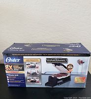Box of Oster 7 Minute Grill with Duraceramic non-stick plates in open box condition, showing brand, features, and usage instructions on packaging.